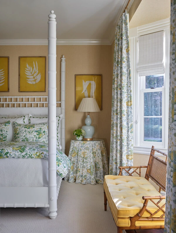 Four poster bed in bedroom with tones of orange and yellow