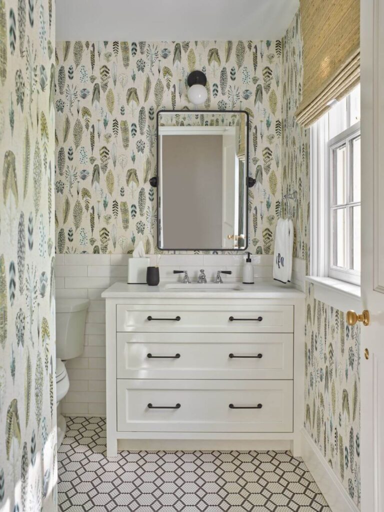 a bathroom with a white vanity and wall paper