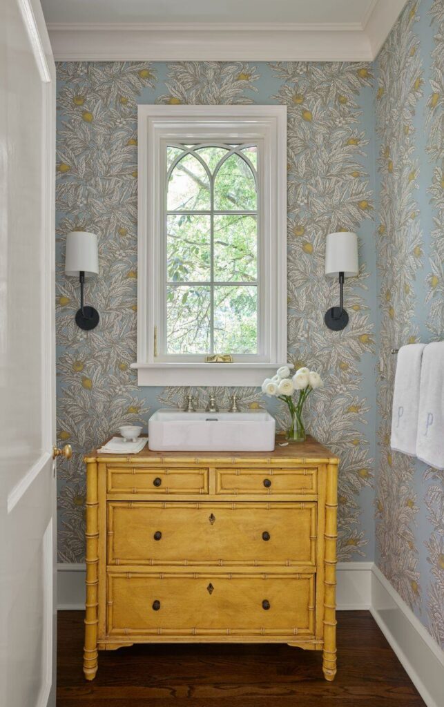 a bathroom with a yellow dresser and white sink